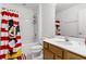 ' bathroom with Mickey Mouse-themed shower curtain and white vanity at 5260 Oakbourne Ave, Davenport, FL 33837