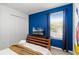 Bright bedroom with twin bed, blue accent wall and large Mickey Mouse decal at 5260 Oakbourne Ave, Davenport, FL 33837