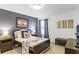 Comfortable bedroom with a queen bed, side tables, and stylish decor with an accent wall painted dark grey at 5260 Oakbourne Ave, Davenport, FL 33837