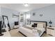 Cozy bedroom with light blue walls, white furniture, and ample natural light at 5260 Oakbourne Ave, Davenport, FL 33837