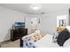 Bedroom featuring carpet, a closet, a dresser with a TV, and ensuite bathroom visible through the doorway at 5260 Oakbourne Ave, Davenport, FL 33837