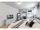 Bright bedroom featuring a comfortable bed, dresser, and natural light at 5260 Oakbourne Ave, Davenport, FL 33837