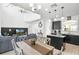 Open dining area features wood table, granite island, seamlessly connecting the kitchen and living spaces at 5260 Oakbourne Ave, Davenport, FL 33837