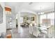 Open floor plan showcasing the dining room with an elegant glass table and seamless flow to the living area at 5260 Oakbourne Ave, Davenport, FL 33837