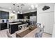 Stylish eat-in kitchen with dark cabinets, stainless steel appliances, and a central island with barstool seating at 5260 Oakbourne Ave, Davenport, FL 33837