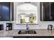 Open kitchen view from the sink area, leading into the dining area and living space at 5260 Oakbourne Ave, Davenport, FL 33837