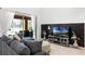 Cozy living room featuring a comfortable sofa, stylish decor, and sliding glass doors to the outdoor patio at 5260 Oakbourne Ave, Davenport, FL 33837