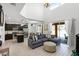 Open-concept living room with view into the kitchen, a large sofa, and natural light from sliding glass doors at 5260 Oakbourne Ave, Davenport, FL 33837