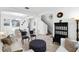 Open-concept living room with modern furniture, light-colored walls, and wood-look floors at 5260 Oakbourne Ave, Davenport, FL 33837