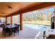 Covered patio featuring outdoor dining, grill, and beautiful pool views at 5260 Oakbourne Ave, Davenport, FL 33837