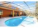 Backyard pool with screened enclosure, patio, and outdoor dining area at 5260 Oakbourne Ave, Davenport, FL 33837