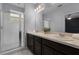 Bathroom featuring dual sinks, a large mirror, and a walk-in shower at 604 Fortanini Cir, Ocoee, FL 34761