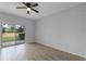 This bedroom features a sliding glass door and wood-look tiling at 604 Fortanini Cir, Ocoee, FL 34761