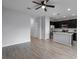 Bright living space with sleek tile floors, ceiling fan, and access to the kitchen at 604 Fortanini Cir, Ocoee, FL 34761