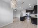 Bright open-concept kitchen and dining area with stylish lighting at 604 Fortanini Cir, Ocoee, FL 34761