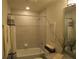 Bathroom showcasing a shower-tub combo with modern fixtures and granite vanity at 6147 Arbor Watch Loop, Orlando, FL 32829