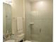 Bathroom featuring tiled walk-in shower with glass door and granite countertop at 6147 Arbor Watch Loop, Orlando, FL 32829