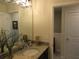 Bathroom showcasing a sink vanity with granite countertop and decorative light fixtures at 6147 Arbor Watch Loop, Orlando, FL 32829