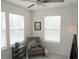 Bedroom featuring ceiling fan, chair, table, and bright windows at 6147 Arbor Watch Loop, Orlando, FL 32829