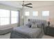Bedroom showcasing comfortable bed, ceiling fan, and abundant natural light from windows at 6147 Arbor Watch Loop, Orlando, FL 32829
