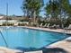 Large community pool with clear blue water and poolside lounge chairs at 6147 Arbor Watch Loop, Orlando, FL 32829