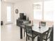 Inviting dining area featuring a modern chandelier, wood table, and a view of the front entry at 6147 Arbor Watch Loop, Orlando, FL 32829