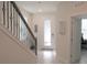 Bright entryway with staircase, decorative wall art, and a tiled floor at 6147 Arbor Watch Loop, Orlando, FL 32829