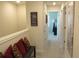 Bright hallway with neutral walls, and decorative wall art, leading to bedrooms at 6147 Arbor Watch Loop, Orlando, FL 32829