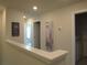 Hallway featuring artwork, doors, and view to bedroom at 6147 Arbor Watch Loop, Orlando, FL 32829