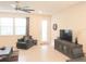 Open-concept living area showcasing neutral walls, tile floors, and an abundance of natural light at 6147 Arbor Watch Loop, Orlando, FL 32829
