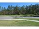 Street view of community with sidewalks, landscaping, and mature trees at 6147 Arbor Watch Loop, Orlando, FL 32829