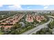 Aerial view of a townhome community with lush landscaping, illustrating the property's serene setting at 6881 Piazza St, Orlando, FL 32819