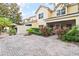 Exterior view of a backyard featuring a brick-paved patio, manicured garden, and privacy fence at 6881 Piazza St, Orlando, FL 32819