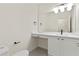 Bright half bathroom features white vanity and sink with modern black fixtures at 6881 Piazza St, Orlando, FL 32819