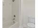 Cozy bathroom showcasing a tiled shower over tub combination and a standard toilet at 6881 Piazza St, Orlando, FL 32819