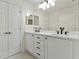Bright bathroom featuring a double sink vanity with modern black hardware and a large mirror at 6881 Piazza St, Orlando, FL 32819