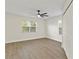 Bright bedroom with hardwood floors, and ceiling fan, providing a comfortable and modern space at 6881 Piazza St, Orlando, FL 32819