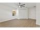 Bright bedroom with neutral walls, ceiling fan, hardwood flooring and a spacious closet at 6881 Piazza St, Orlando, FL 32819