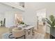Spacious dining area with modern furnishings, open floor plan, and hardwood floors at 6881 Piazza St, Orlando, FL 32819