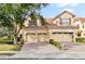 Charming home with a red tile roof, brick driveway, and manicured landscaping, enhancing its curb appeal at 6881 Piazza St, Orlando, FL 32819