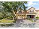 Charming two-story home with a three car garage, tile roof and well-manicured landscaping at 6881 Piazza St, Orlando, FL 32819