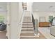 Light-filled foyer showcasing a staircase with wood treads and a view into the spacious living area at 6881 Piazza St, Orlando, FL 32819