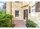 Inviting front entrance with beautiful landscaping and brick walkway leading to a brown front door at 6881 Piazza St, Orlando, FL 32819