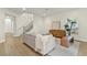 Open-concept living room featuring a staircase with black wrought iron and a bright neutral color palette at 6881 Piazza St, Orlando, FL 32819