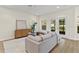 Bright living room with modern furnishings, neutral decor, and sliding glass doors to the outdoors at 6881 Piazza St, Orlando, FL 32819