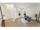 Inviting living room with wood-look flooring, designer furniture, and plenty of natural light at 6881 Piazza St, Orlando, FL 32819