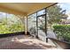 Enclosed patio with brick flooring, offering a private outdoor space surrounded by lush greenery at 6881 Piazza St, Orlando, FL 32819