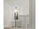 Bright staircase features iron railing, wood steps, and a pendant light under a high ceiling at 6881 Piazza St, Orlando, FL 32819