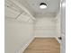 Empty walk-in closet with wire shelving and hardwood flooring at 6881 Piazza St, Orlando, FL 32819