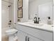 Modern bathroom with white vanity, sleek black faucet, framed botanical art, and shower with tub combo at 8718 Sw 139Th Place Rd # 29, Ocala, FL 34473